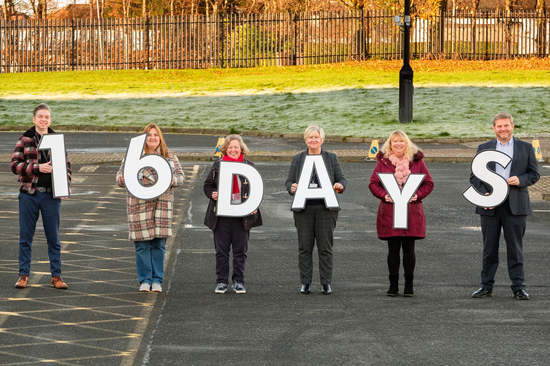 Staff holding cutouts of numbers and letters to read 16 DAYS, marking the 16 Days of Action campaign