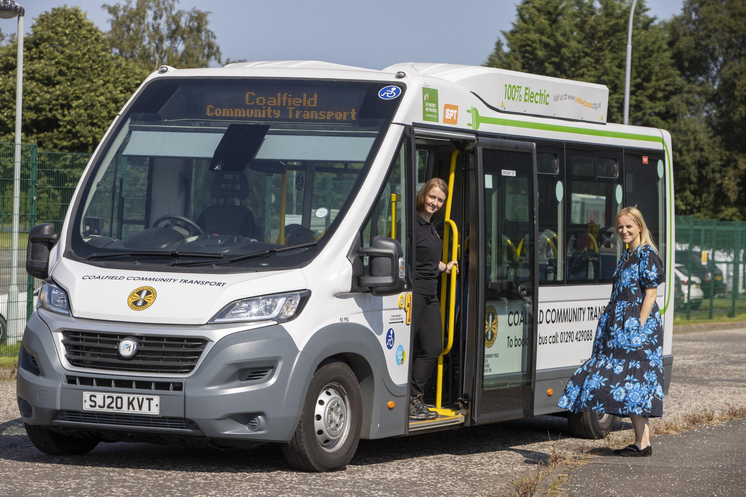 community bus with a driver at the door and a resident smiling at the camera