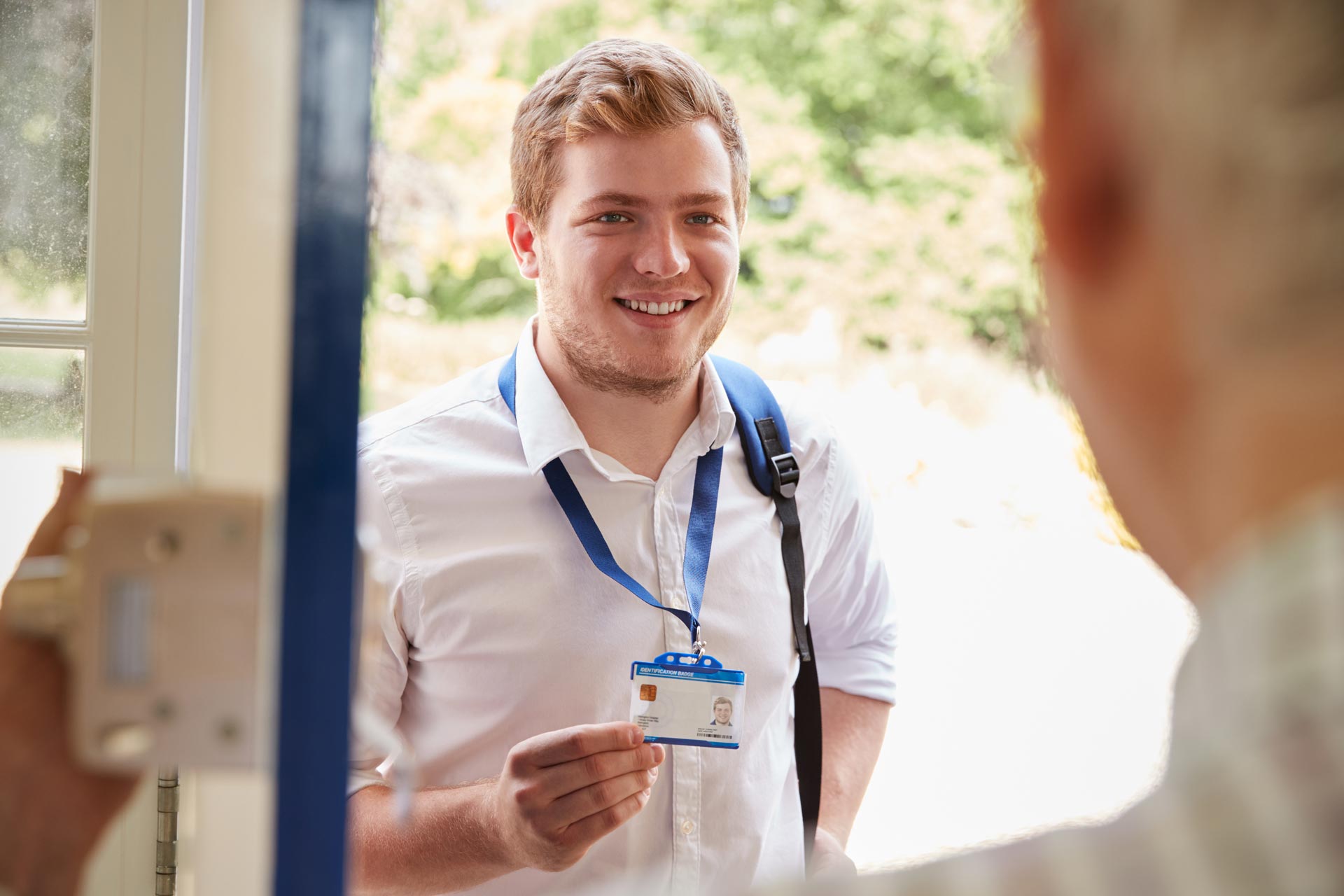 man at front door showing ID