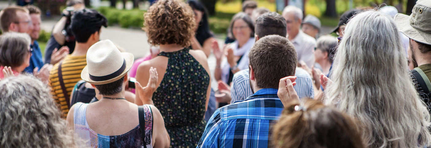 group of people outside clapping