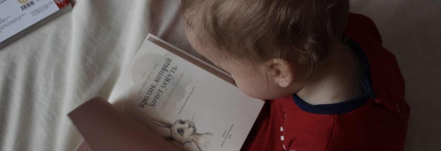 a toddler reading a book