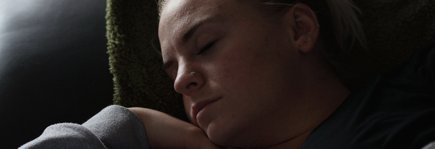 close-up of a woman sleeping on a chair