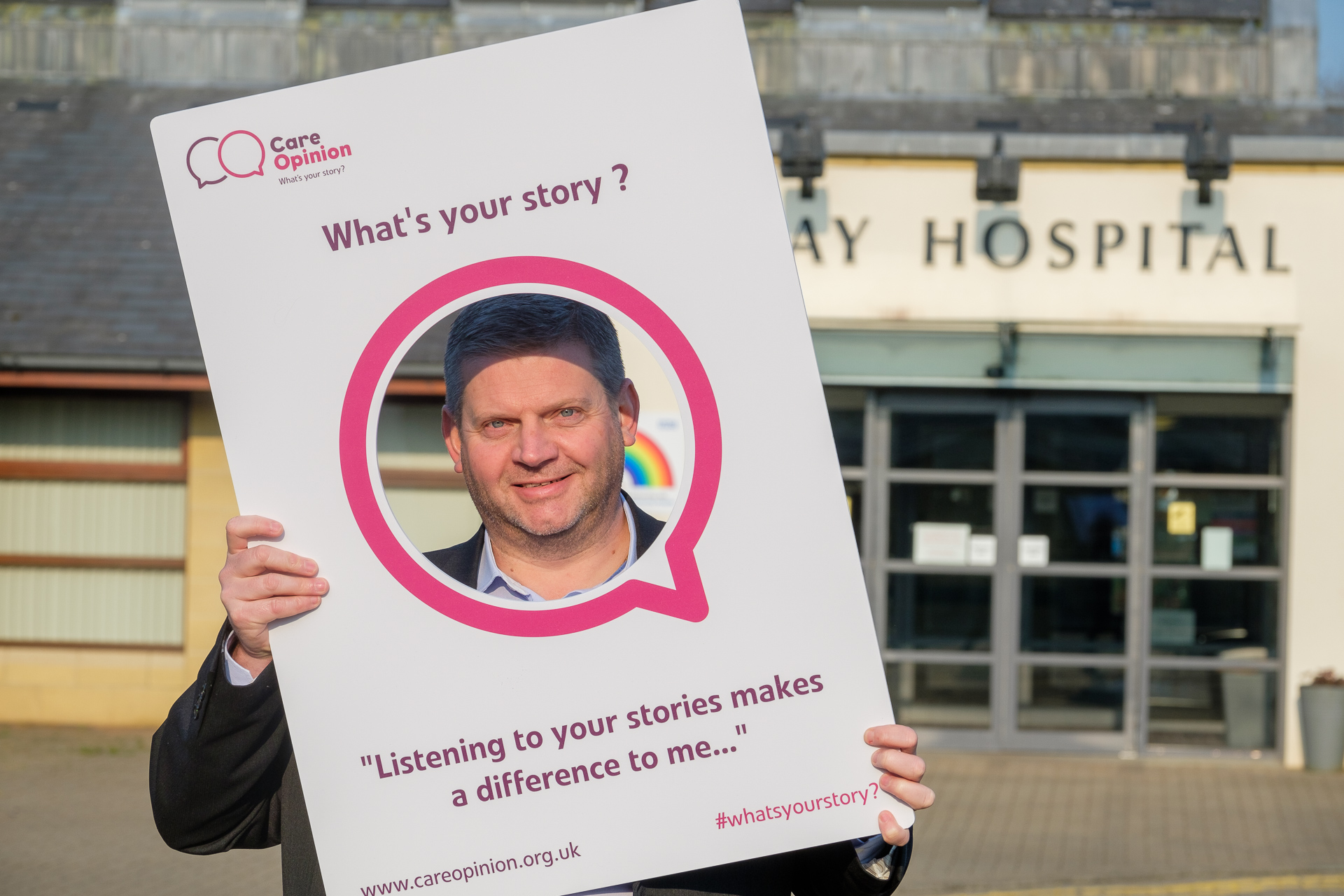 Craig McArthur, Director of East Ayrshire Health and Social Care Partnership holding a Care Opinion 'selfie-board'