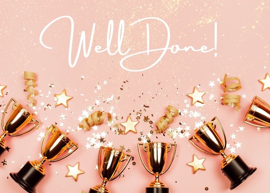 trophies and confetti against a pale pink background with the words 'Well Done!' in white