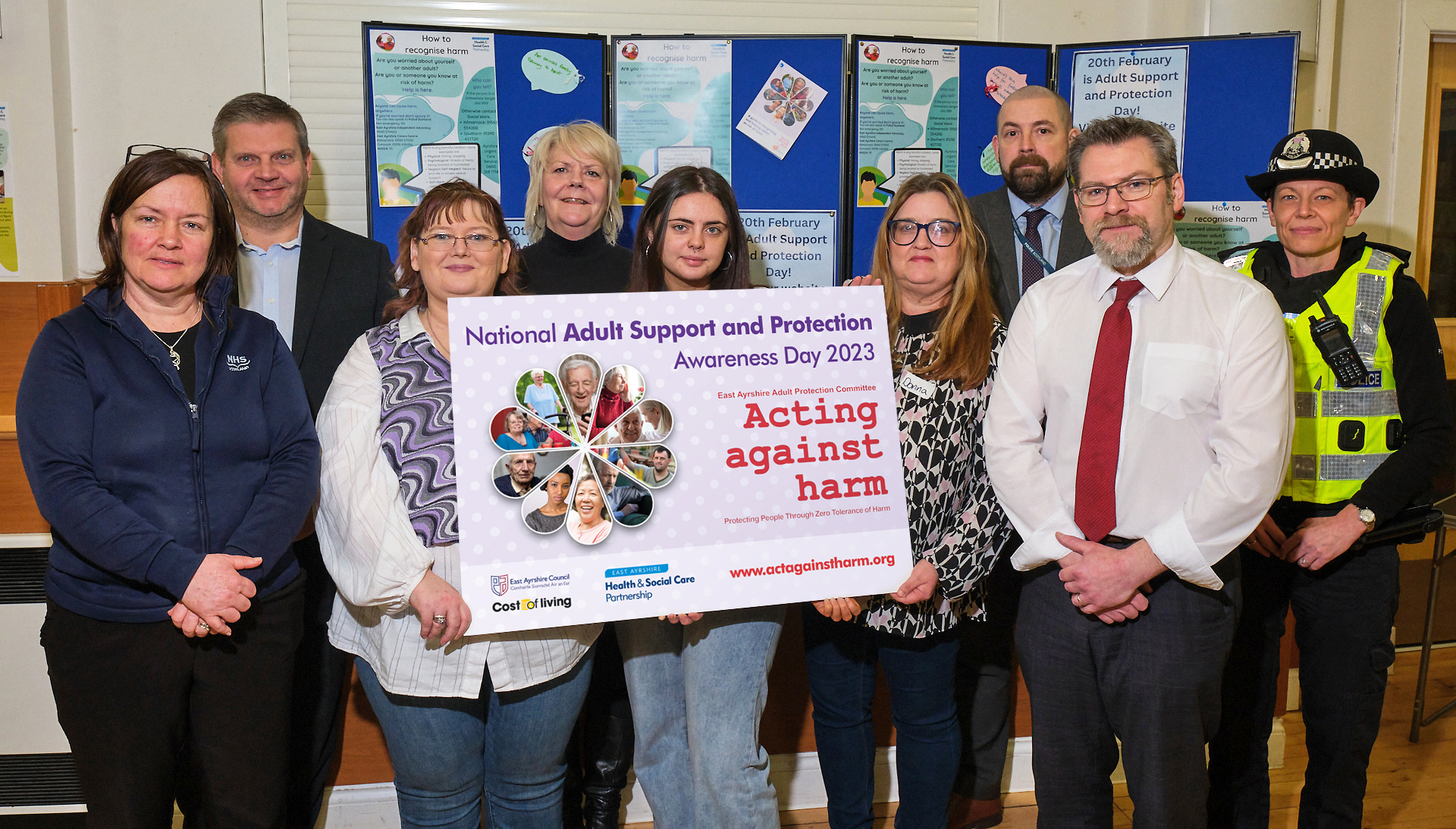 EAHSCP staff and partners holding up a sign in support of Adult Support and Protection Day 2023