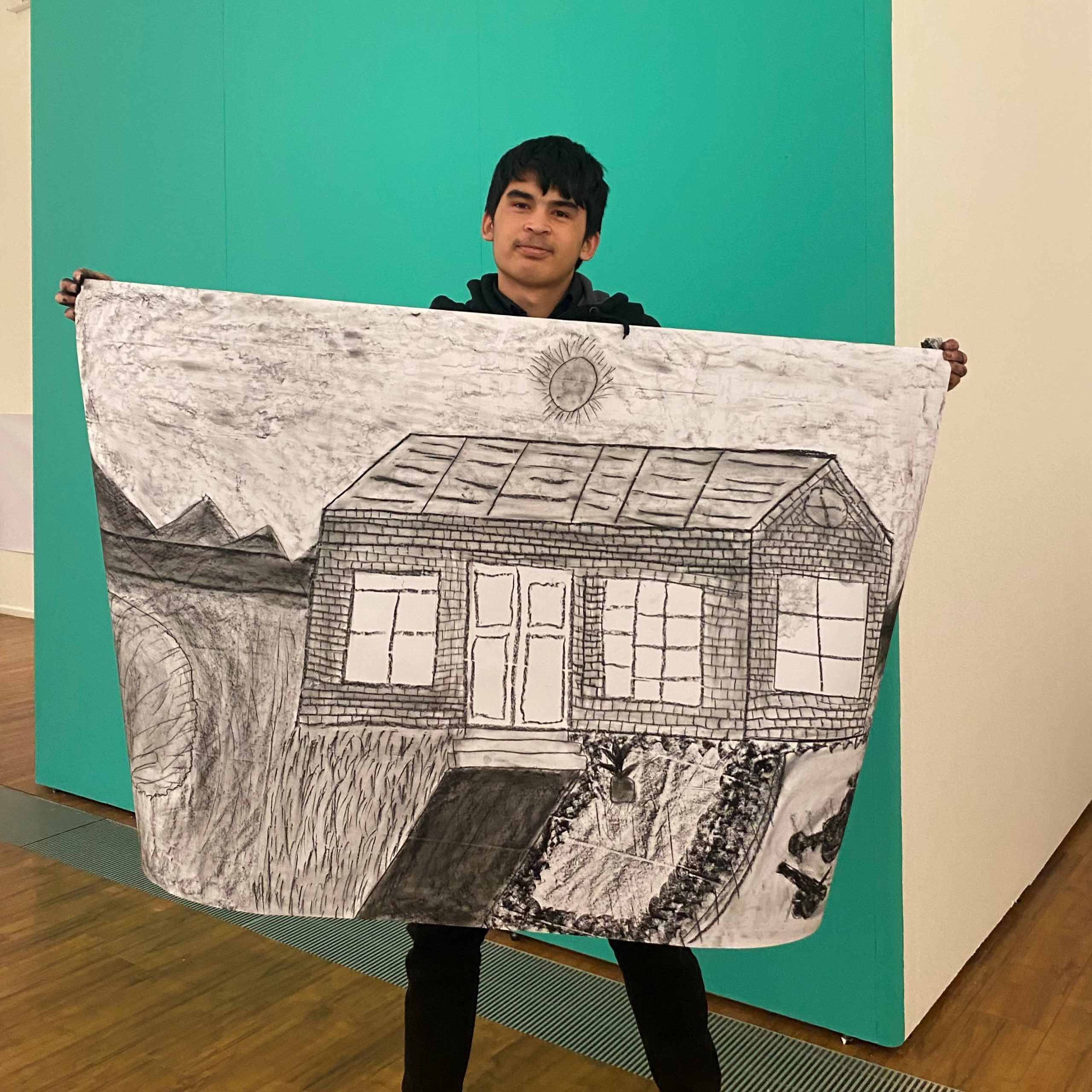 ArtClub? participant Mahdi with his drawing 'A Charcoal Day'.
