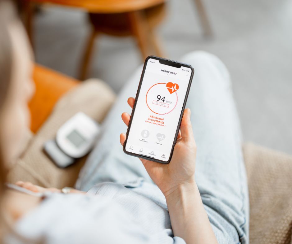 A woman using a blood pressure monitoring app on her phone