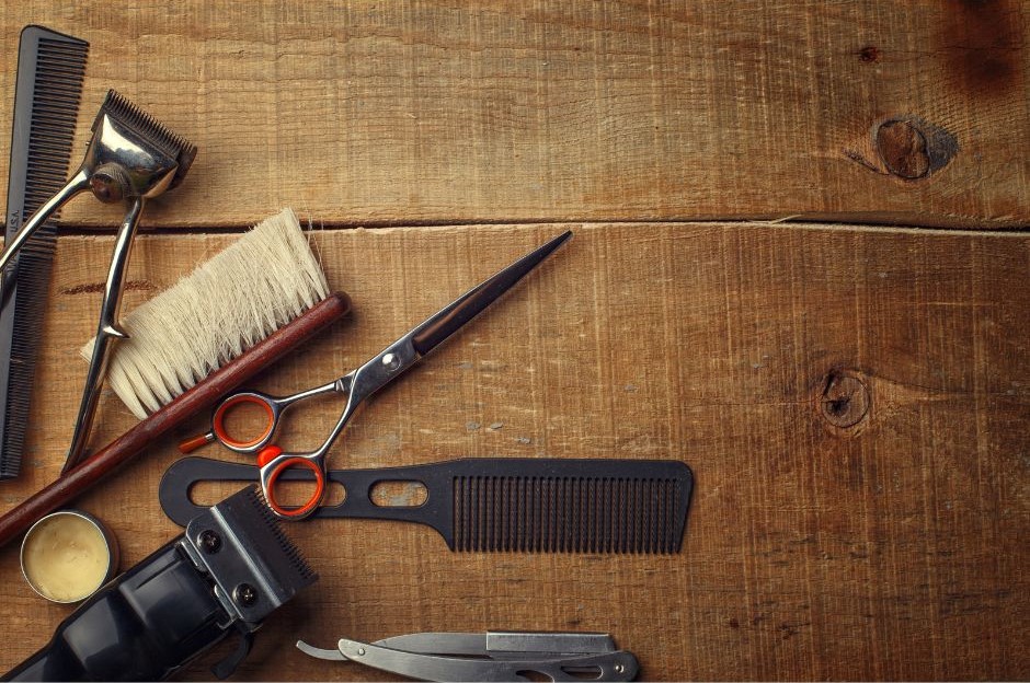 A table with a range of barbering scissors and tools